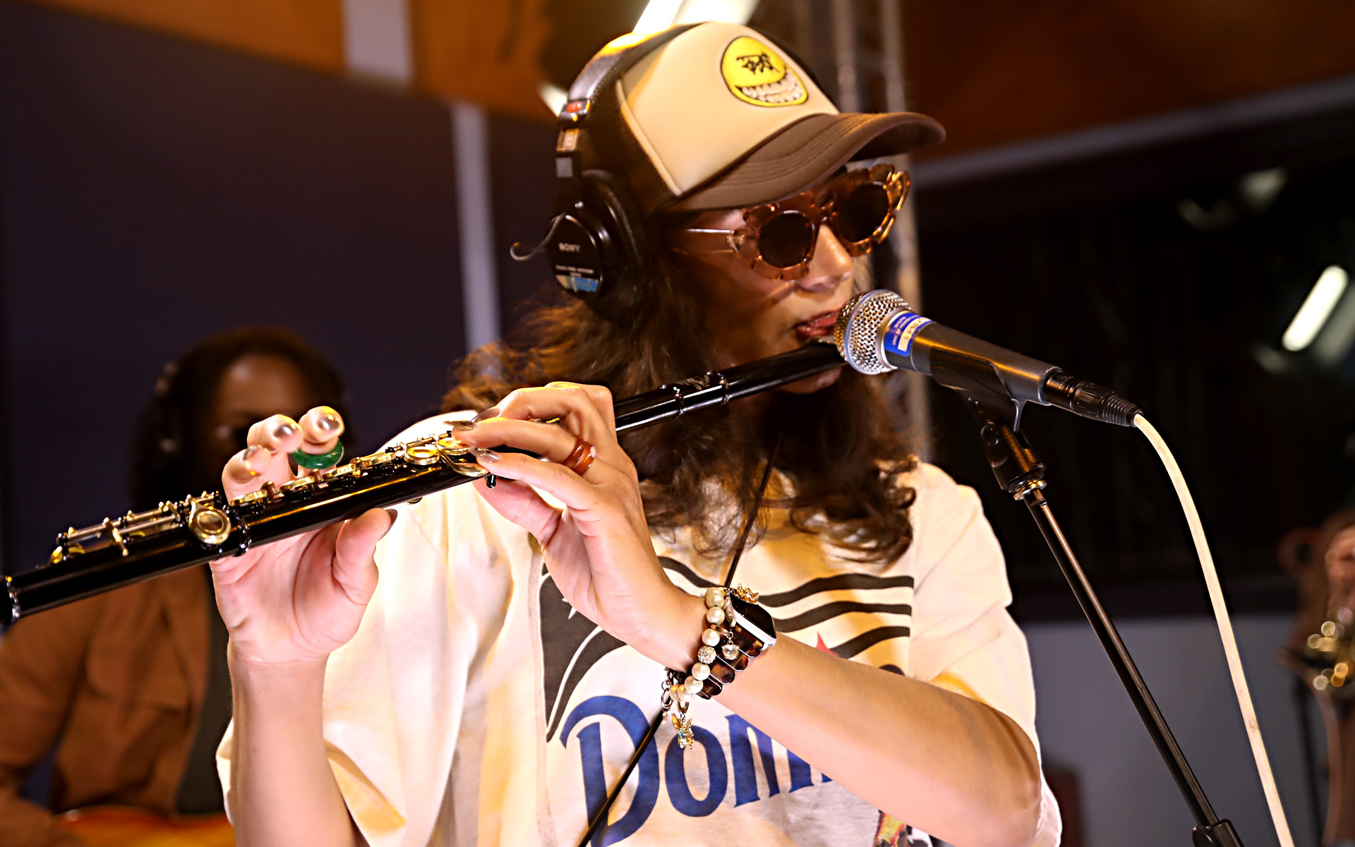 Brielle Kimmins, aka AprilFoolChild, playing flute in a recording studio.