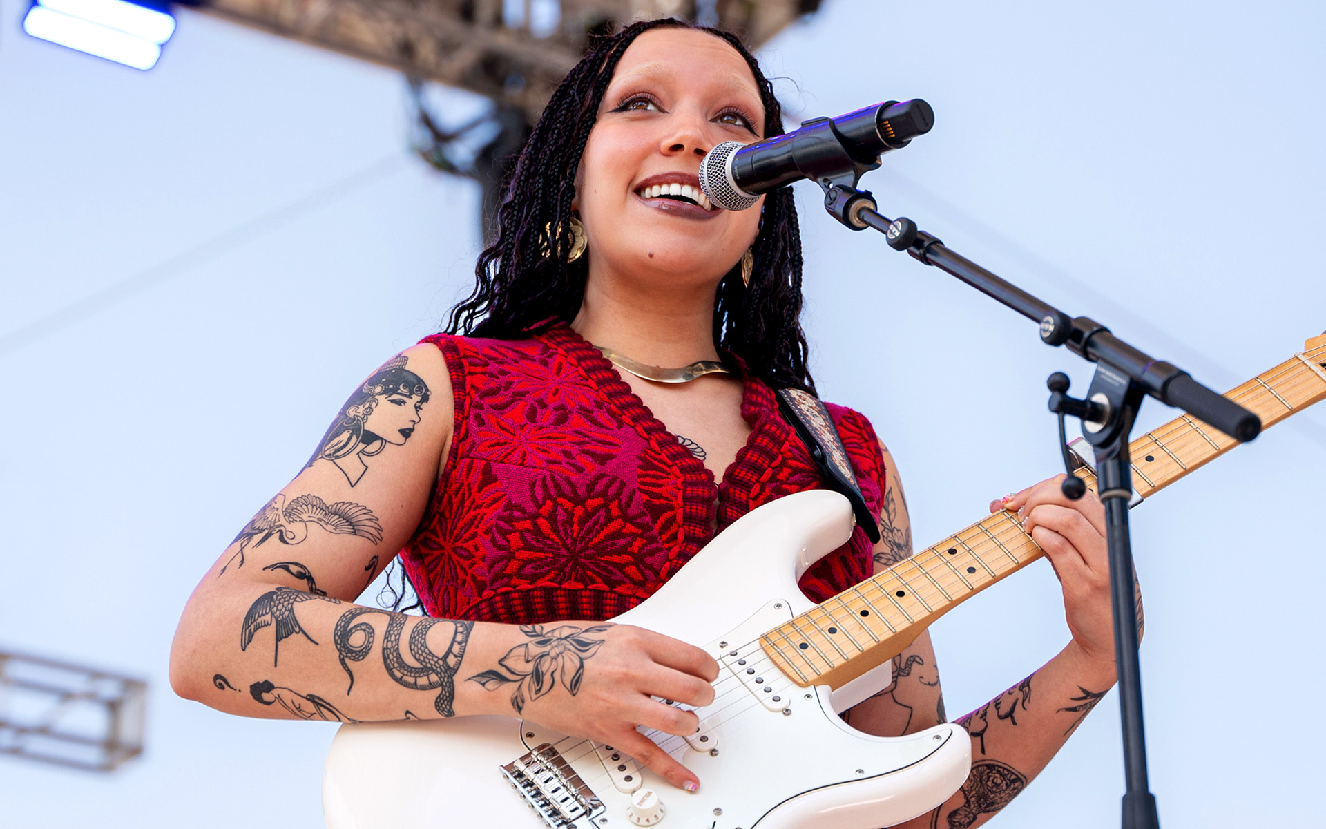 Julia Pratt onstage outside with an electric guitar